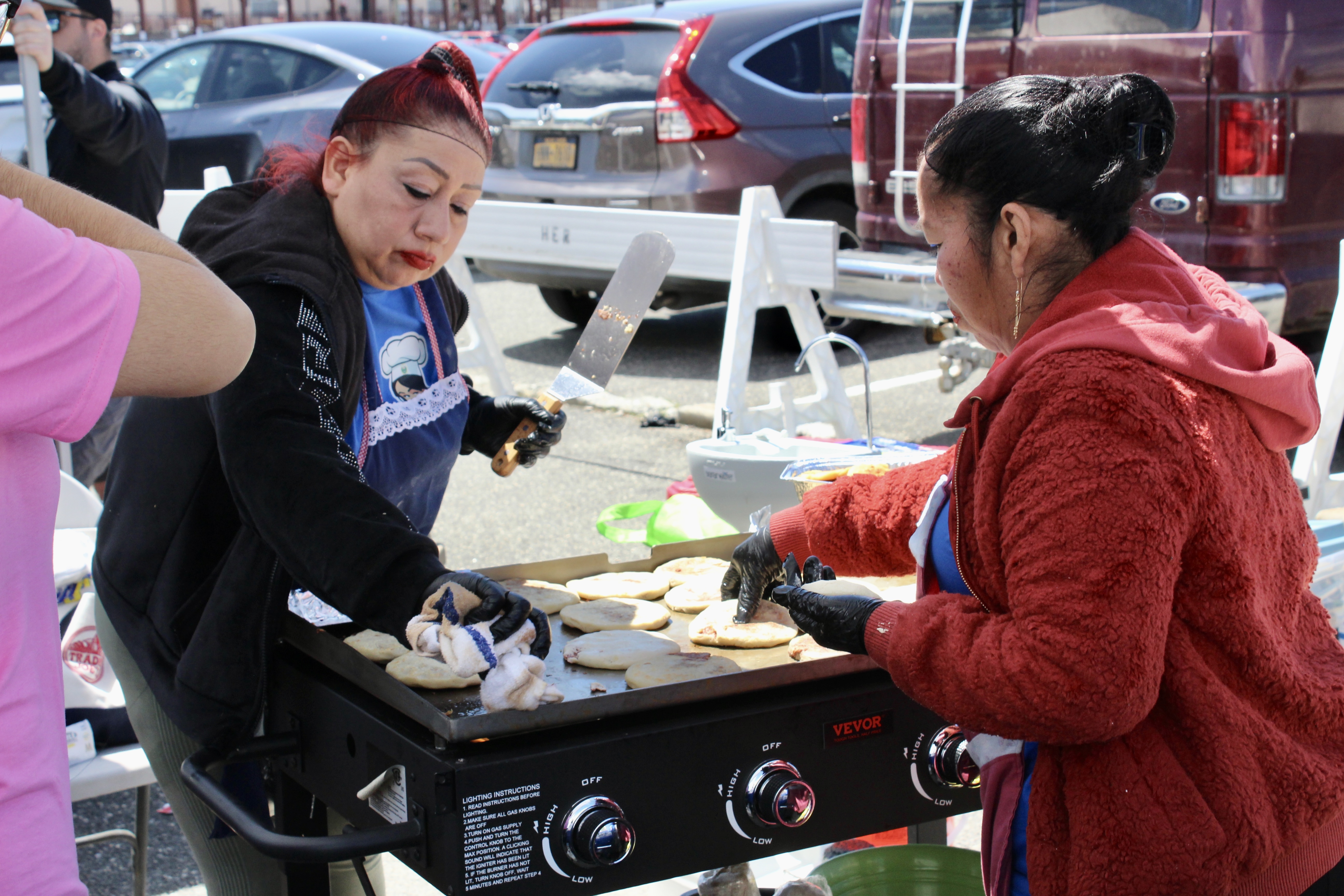 Women prepare pupusas.