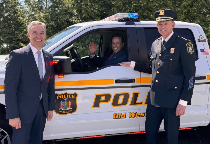 State Sen. Jack Martins (L.) joined with former Old Westbury Mayor Fred Carillo (C.) and Old Westbury Chief of Police Stuart Cameron (R.) in unveiling the Old Westbury Police Department's first electric vehicle.