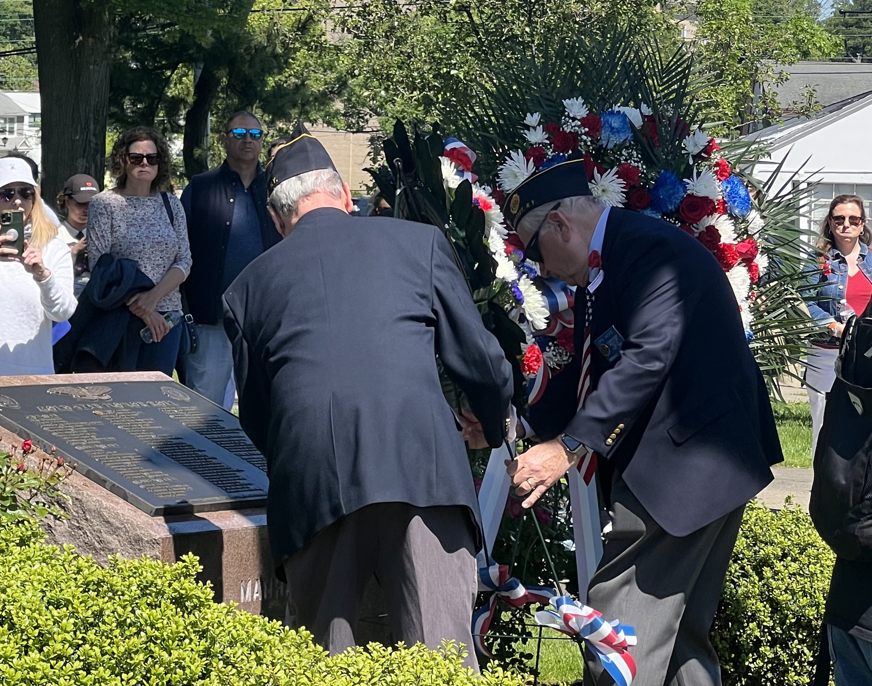 Manhasset American Legion members place funeral wreaths at the memorial site at Mary Jane Davies Park.