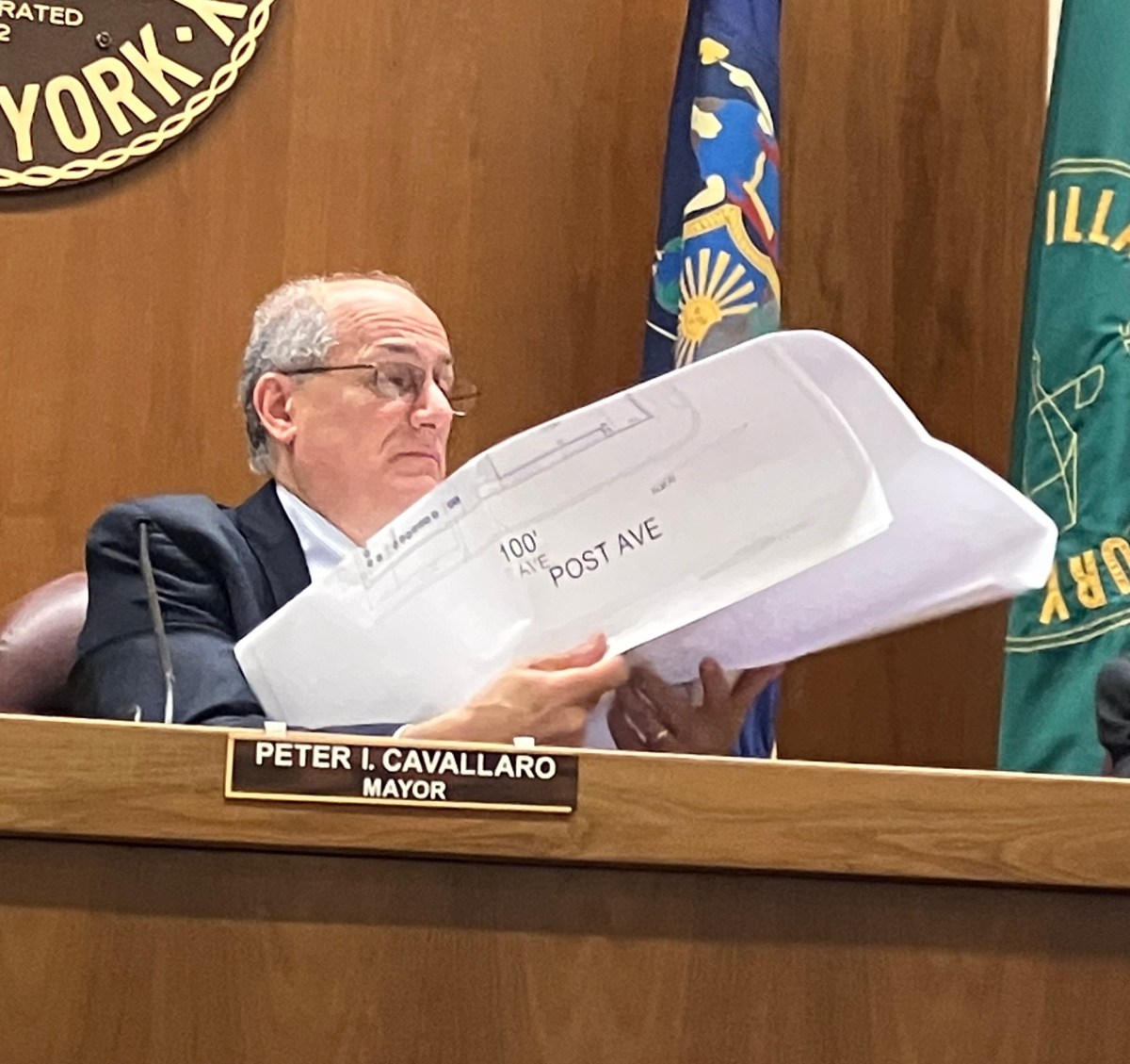 Westbury Mayor Peter Cavallaro looking at Cena 081's revised site maps during Thursday's meeting.