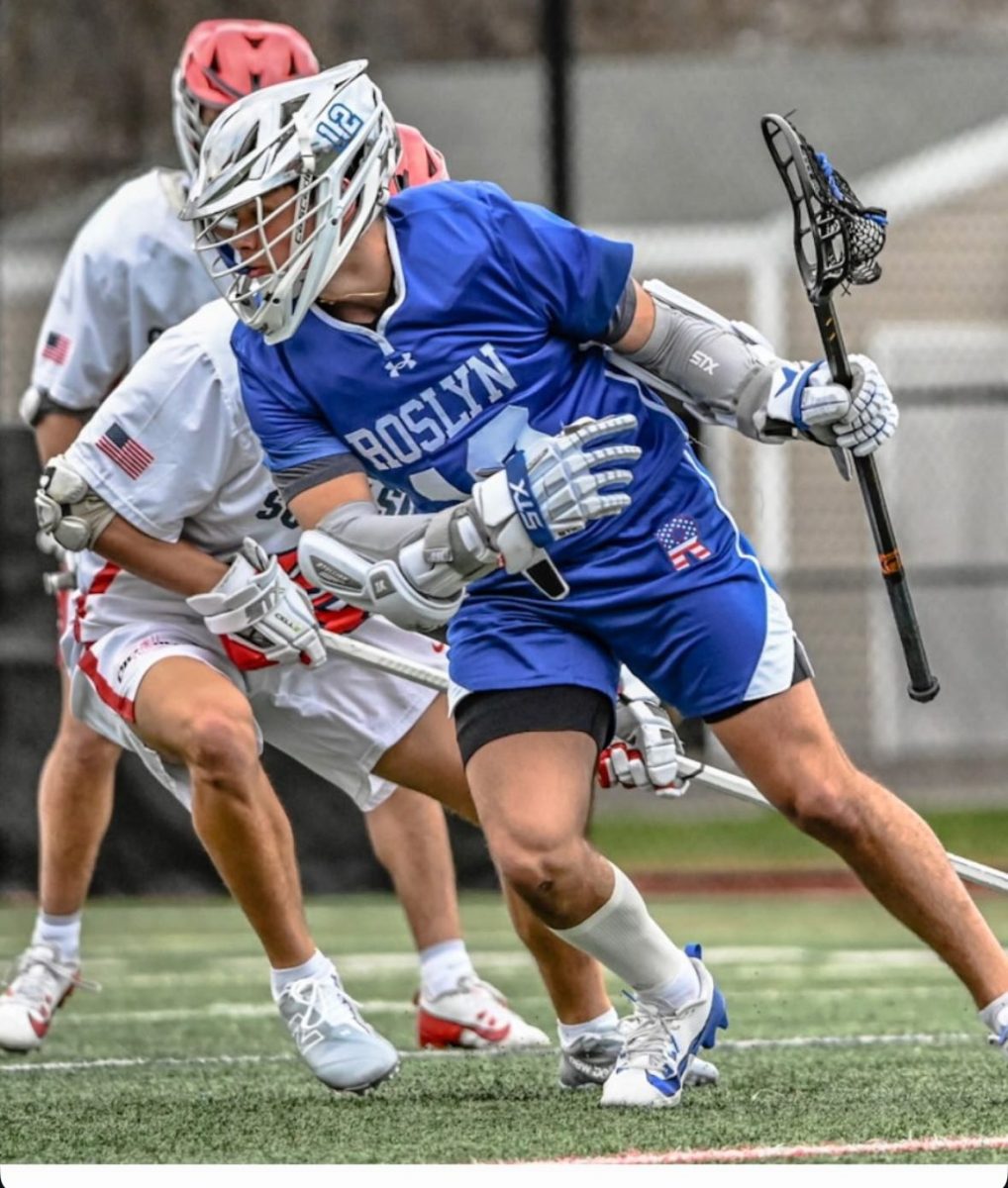 Roslyn junior lacrosse star Josh Berger (in blue) has 42 goals through the team's first 10 games this season. Photo credit: Michelle Ebel.