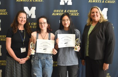 Spanish teacher Pamela Schellberg, left, and Massapequa High School Principal Barbara Lowell congratulated Silvia Izquierdo and Chloe Goldberg on their awards in the Long Island Language Teachers student language competition.