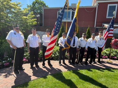 Veterans holding the American Flag during the Village of Farmingdale's Memorial Day parade