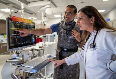 Dr. Avneet Singh (L.) and Dr. Nisha Parikh (R.) review pressure tracing that monitors blood flow in the coronary arteries.