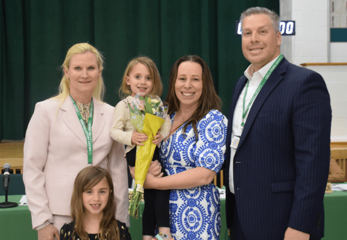 Superintendent Kristen Turnow, sixth-grade teacher Ann Monsees with her children and middle school principal Michael Cestaro (L. to R.).