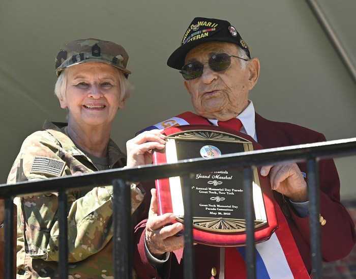 Grand Marshal and World War II veteran Harold Radish is given an award for his service.