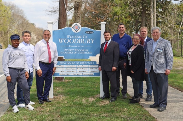 Town of Oyster Bay officials and Syosset-Woodbury Chamber of Commerce board members celebrate the new "Welcome to Woodbury" sign on Jericho Turnpike.
