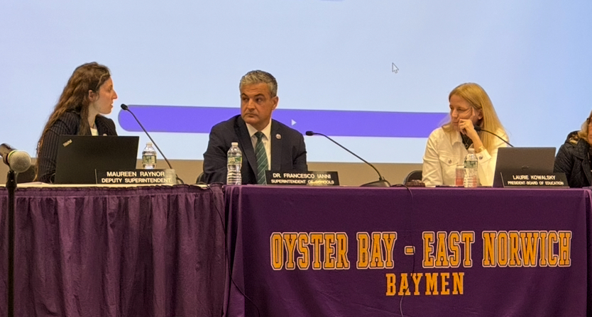 Deputy Superintendent Maureen Raynor, Superintendent Francesco Ianni and Board President Laurie Kowalsky (L. to R.) discuss district restructuring at the Oyster Bay-East Norwich Board of Education meeting.