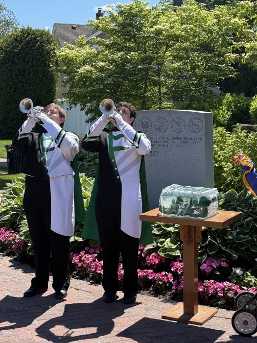 Residents in front of a memorial in Farmingdale