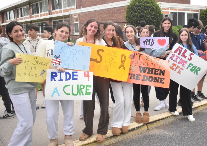 Ninth graders held up signs of encouragement for ALS patients.