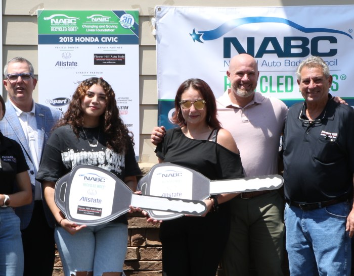The Romero family surrounded by Flower hill Mayor, Randall Rosenbaum, NABC representative, and Flower Hill Auto Body President Jack Picciano.