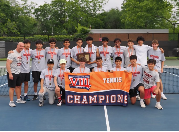 The Syosset boys tennis team celebrates its third consecutive state championship victory.
