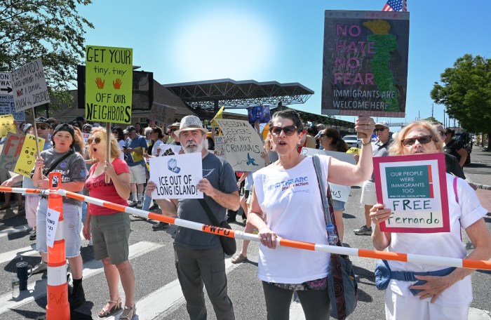 Residents brought signs reading "Immigrants are welcome here" and "ICE out of Long Island"