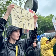 A protester holds a sign reading "get ICE out of Port" at the No Kings rally in Port Washington.