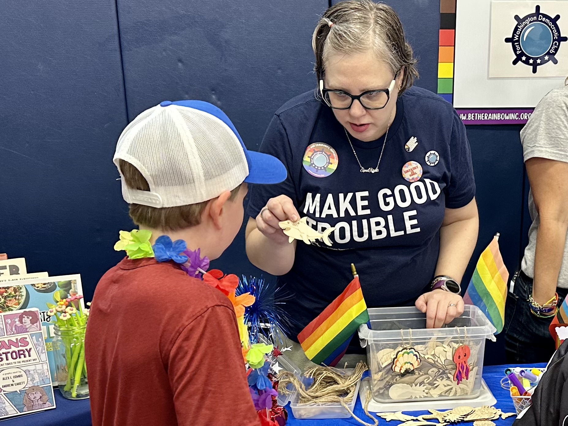 Kids do arts and crafts at the Be The Rainbow Pride celebration.