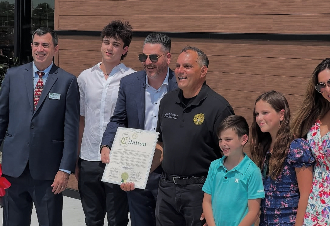 Brian Levy and Oyster Bay Town Supervisor Joseph Saladino (C.) celebrate the grand opening of Levy's new location in Syosset.