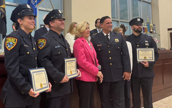 Mayor Pam Panzenbeck (Center L.) and Deputy Chief Chris Ortiz (Center R.) recognize three police officers who had gone into the building during the Glen Cove Avenue apartment fire in April, at meeting where council amends noise ordinance.