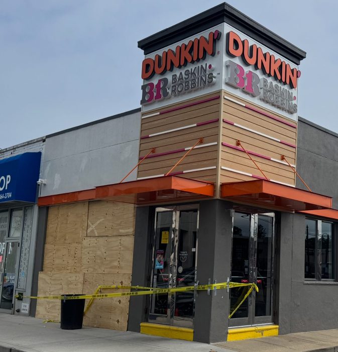 The front of the Jackson Avenue Dunkin Donuts is boarded up after a car struck it.
