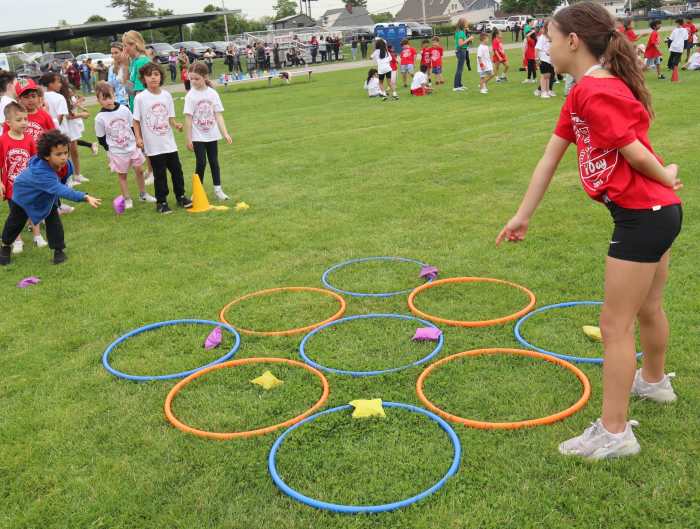 Teams tossed beanbags into correctly colored hoops.