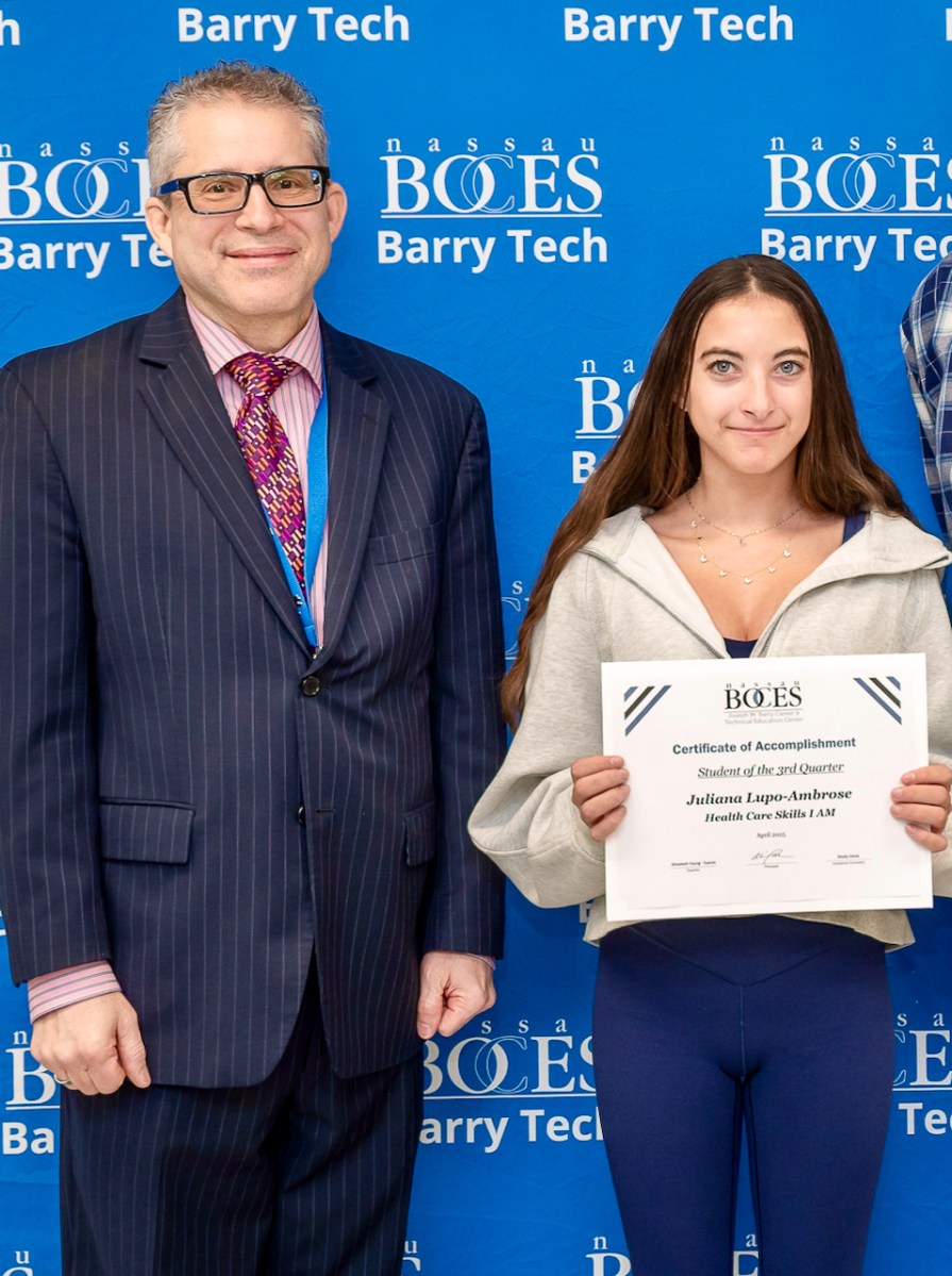 Juliana Lupo-Ambrose (R.) of Plainview-Old Bethpage is congratulated on being named Barry Tech Student of the Quarter by Principal William Poll.