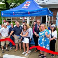 WaterFront Center President Elisa Santoro (C.) cuts the ribbon along with Executive Director George Ellis (Center L.) to celebrate the nonprofit's 25 year anniversary.