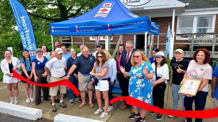 WaterFront Center President Elisa Santoro (C.) cuts the ribbon along with Executive Director George Ellis (Center L.) to celebrate the nonprofit's 25 year anniversary.