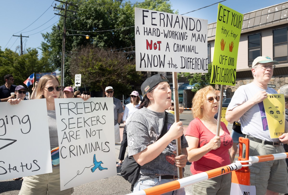 Port Washington ralliers hold up signs in support of Fernando Mejia