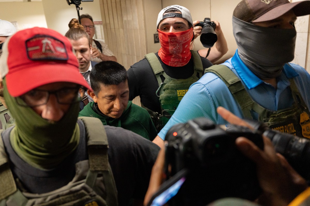 Masked Immigration and Customs Enforcement agents arresting a noncitizen inside 26 Federal Plaza in Lower Manhattan.