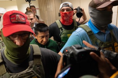 Masked Immigration and Customs Enforcement agents arresting a noncitizen inside 26 Federal Plaza in Lower Manhattan.