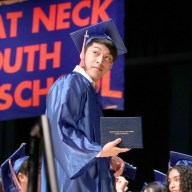 A Great Neck South High School senior walks across the stage after receiving his diploma.