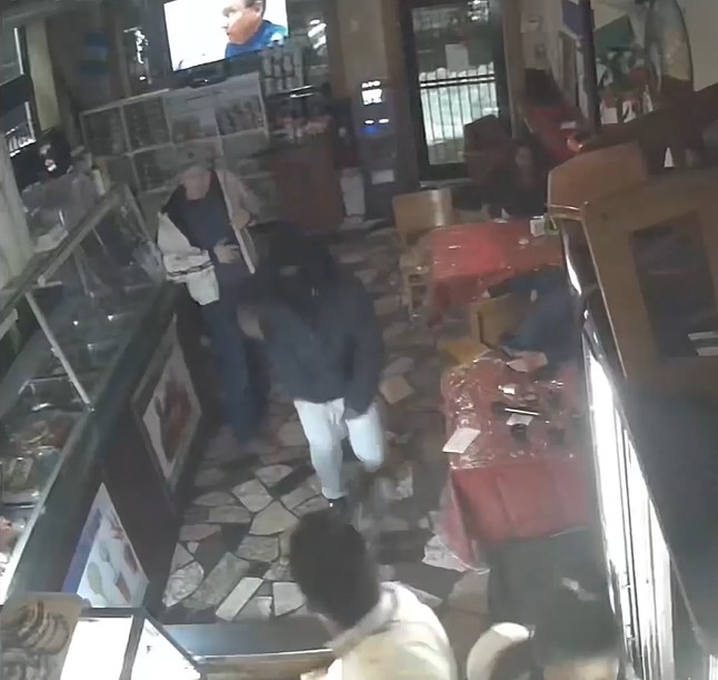 Deshawn Martin (C) holds up the Antojitos Express restaurant in Hempstead at gunpoint on January 30, 2022.