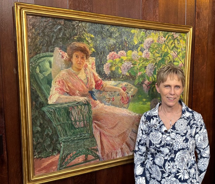 Janice Wiley, director of the Church Catalogue Raisonne, celebrates the exhibition's opening at the North Shore Historical Museum.