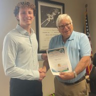 East Hills Mayor Michael Koblenz presented Tyler Osit, a member of the East Hills Blood Drive committee, with a certificate for his work.
