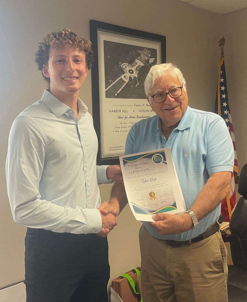 East Hills Mayor Michael Koblenz presented Tyler Osit, a member of the East Hills Blood Drive committee, with a certificate for his work.