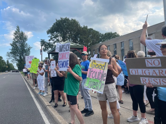 Protesters gather outside the Nassau County Police Department to honor John Lewis’s legacy and denounce county collaboration with ICE and threats to civil liberties.