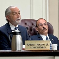 North Hempstead Town Council Member Robert Troiano (L.) proposed that an amendment be made in the future to provide greater relief to innocent homeowners affected by the building department's corruption.