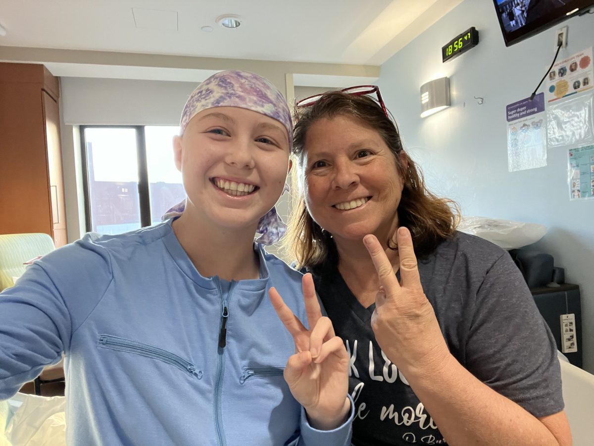 Kelly Mullooly (L.) and her mother (R.) at Cohen Children's Medical Center after she received treatment for a cancerous tumor in her left knee.
