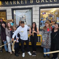 Laura Escobar (Third from R.) cuts the ribbon at Hive Market & Gallery's four year anniversary.