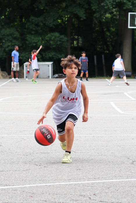 Campers practice their basketball skills on the court at LuHi.
