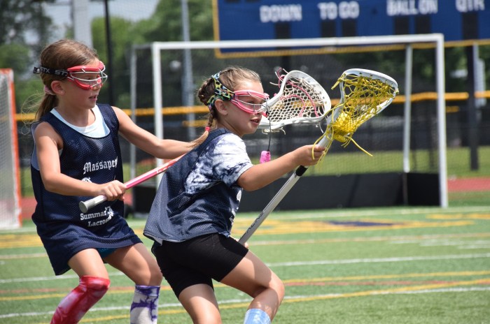 Hailey Jurgens, (L.) and Cynthia Galasso (R.) competed for the ball in the girls lacrosse camp. 