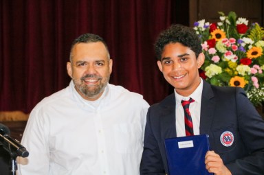 Rowan Subbaiah won three awards, earning the highest marks in History, Math, and Science. He is pictured here with veteran Buckley science teacher Roger Persaud.