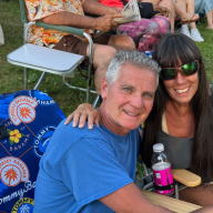 Concertgoers at the Morgan Park Summer Music Festival kickoff concert bring chairs and blankets to enjoy the show.