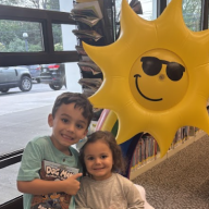 Children celebrate summer reading by taking out books from the Syosset library.
