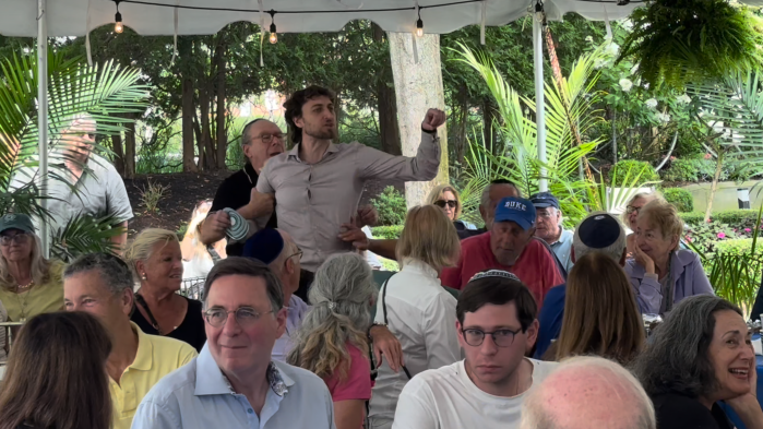 One climate activist was dragged away from The Hamptons Synagogue, yelling that EPA Administrator Lee Zeldin was a monster.