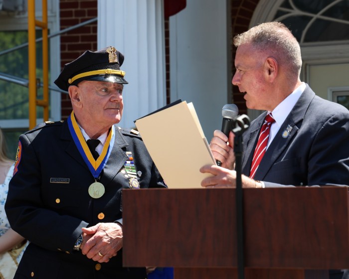 Timothy Jaccard (L.) was honored by state Sen. Steve Rhoads (R.) for his service after founding the AMT Children of Hope Foundation in 1998.