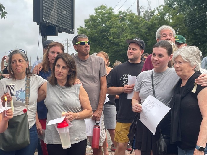 Residents wrapped their arms around each other during the rally.