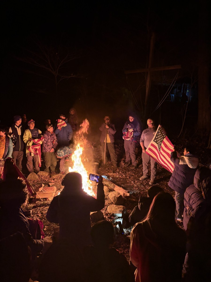 The Scouting America youth of Great Neck around the campfire at Camp Somers facility of the Mount Allamuchy Scout Reservation.