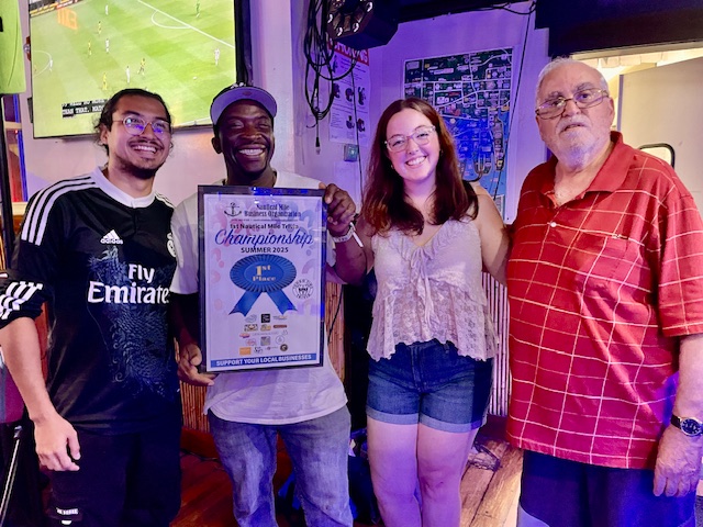 The winners of the Nautical Mile Trivia Championship with the owner of Hurricane Harry's, where the final round was held.