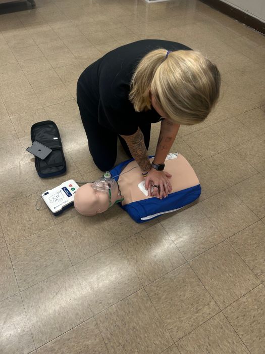 CPR/AED instructor performs aid on a training dummy for the Wantagh Middle School Cardiac Emergency Response Team.