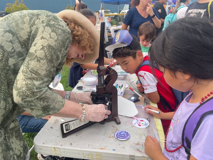The Art Guild helped children make free buttons that featured the children's drawings.
